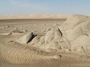 Grey-white rocks and sand dunes in the Namib Desert