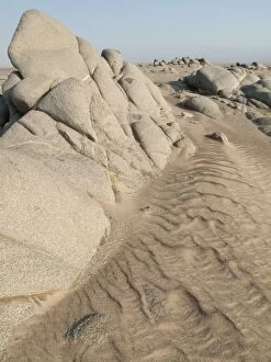 Grey-white rocks in the sand of the Namib Desert