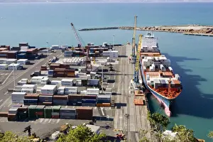 Ports Prints: Harbour - containers stacked on quayside and container cargo ship in harbour and docks