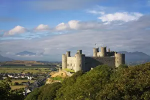 Village Prints: Harlech Castle - over looking Harlech village with Snowdon showing through the clouds in the distance - September