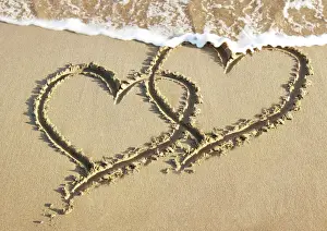 Love Prints: Heart drawn in the sand of a beach Digital Manipulation: added hearts together & sea