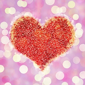 Heart on glowing light background with glitter and bokeh