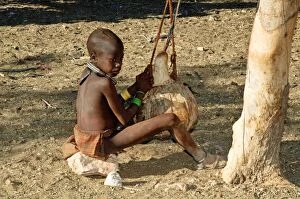 Himba boy - churning milk