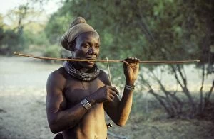 Bushmen Gallery: Himba man playing a stringed instrument - the head