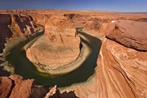 Horseshoe Bend - dramatic view of a nearly 360 degree bend of the Colorado river cut into the colorado plateau
