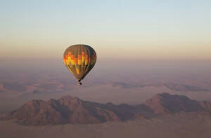 The hot-air balloon above an arid plain and isolated