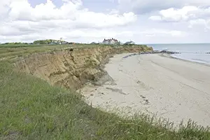Norfolk Prints: Houses on edge of severely eroded cliffs Happisburgh North Norfolk Coast UK