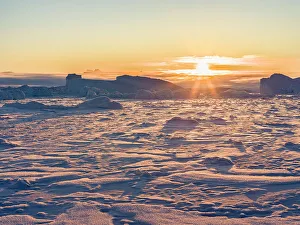 Uummannaq Collection: Icebergs frozen into the sea ice of the Uummannaq fjord system during winter