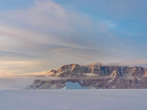 Uummannaq Collection: Icebergs in front of Storen Island, frozen into the sea ice of the Uummannaq fjord system during