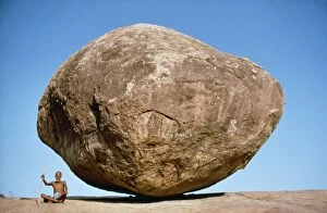 India - Holy man & large boulder