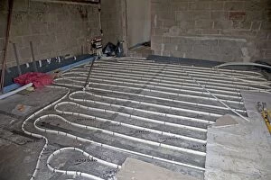 Images Dated 31st May 2010: Installing underfloor heating pipes in new office building - Cheltenham - UK