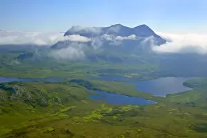 Inverpolly Nature Reserve view from Stac Pollaidh over Loch Sionascaig to Suilven with it's summit enveloped in dispersing clouds Inverpolly Nature Reserve, Wester Ross, Highlands, Scotland, UK
