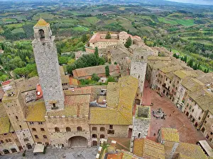 Village Prints: Italy, Tuscany, San Gimignano. View from the Torre Grossa over the rooftops of San Gimignano and the Tuscan countryside