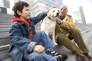 Images Dated 9th April 2005: Labrador - sitting on steps with man and boy