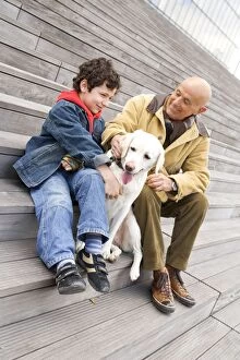 Labrador - sitting on steps with man and boy