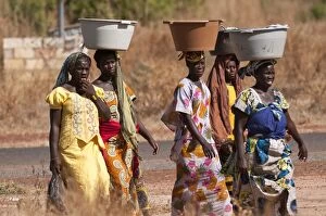 Ladies - carrying washing in bowls on heads