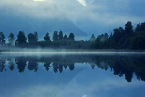 South Island Collection: Lake Matheson - perfect reflection of treeline and mountains of the Southern Alps in Lake Matheson