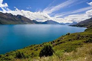 Lake Wakatipu surrounded by stunning mountains with dispersing clouds after a heavy thunderstorm Queenstown, Otago, South Island, New Zealand