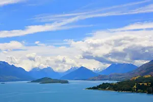 Lakes Prints: Lake Wakatipu view towards the stunning mountains of Mount Aspiring National Park with dispersing clouds after a heavy