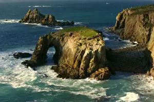 Sea Stacks Prints: Lands End rugged coastline with rock arch in last evening light Lands End