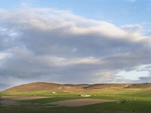 Landscape with farms, fields and hills during sunset, Orkney islands, Scotland