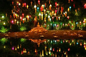 Buddhism Gallery: Lanterns and candles reflected in a pool with a