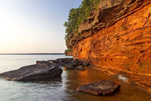 Layered sandstone cliffs and sea caves at