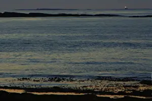 Lighthouse on the Farnes-twilight over the North Sea, from beach at Dunstan Steads, looking towards Farne Isles, Northumberland Uk