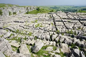 England Prints: Limestone pavement above Malham Cove has been deeply eroded by acid rain leaving clints (lumps of limestone)
