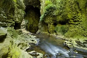 Limestone Tunnel - river flows through a deep and narrow gorge into a cave-like limestone tunnel