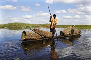 Man - fishing, in boat with fish traps in Bangweuleu Marsh