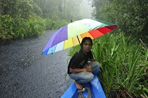 Man - guide on the boat with heavy rain on the way
