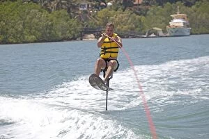 Man riding above water on air chair