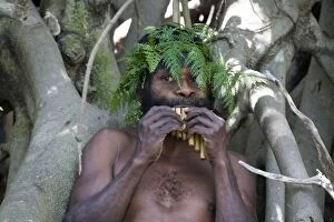 Bamboo Gallery: Man from Tanna Island, Vanuatu, playing bamboo