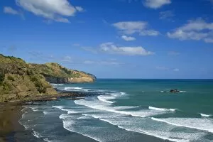 Maori Bay - waves rolling ashore the black sand beach of Maori Bay