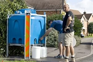 Images Dated 26th May 2007: Two men collecting plastic containers of clean