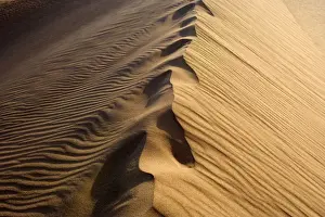 Mesquite Flat Sand Dune - obscured foot steps on the crest of a sand dune in early morning light. The dunes are made up of quartz and feldspar - Death Valley National Park, California, USA