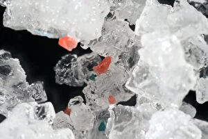 Microplastics on table salt. Tiny fragments