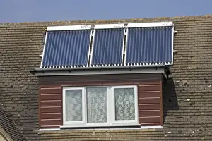Heating Prints: Modern solar panels on roof of detached house Cotswolds UK