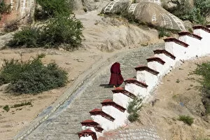 Walking Gallery: Monk walking the stairs in Drepung Monastery, one