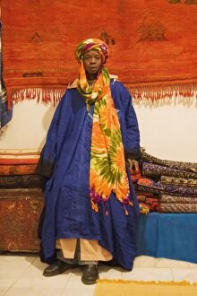 Carpets Gallery: Morocco - Colourful outfit of an employee in a