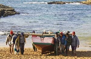 Morocco - Fishermen carry the fishing boats up