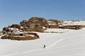 Morocco - Snowed up Berber village and skier in