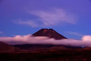 Dusk Prints: Mount Ngauruhoe peak of perfectly shaped volcanoe Mt Ngauruhoe sticking out of clouds at dusk Tongariro National Park