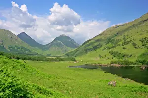Lakes Prints: Mountain scenery Buachaille Etive Beag and Mor with small lake and blooming rhododendron shrubs Glen Etive