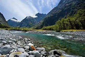 New Zealand Prints: Mountain scenery Hollyford river flowing down Hollyford valley surroundend by high mountains Fjordland National Park