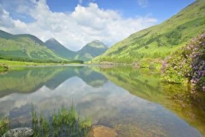 Mountain Scenery - reflection of Buachaille Etive Beag and More in lake during springtime with dense growth of