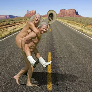 Naked couple wearing cowboy boots and hat crossing road in Monument Valley, Arizona Date: 27-03-2021