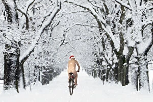 Naked male with Christmas hat on bike riding