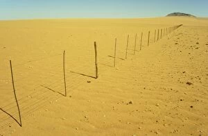 Namibia - Dry Season - fence separating farmland